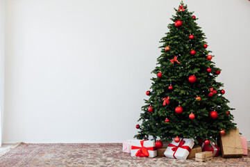 Beautiful holdiay decorated room with Christmas tree with presents under it