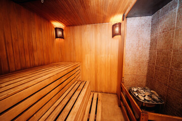 Sauna steam bath inside with stones and stove