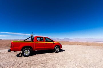 Fototapeta na wymiar red mining pickup truck in the altiplano Atacama desert