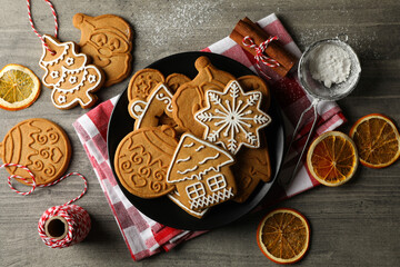 Concept of holiday food with Christmas cookie on gray table