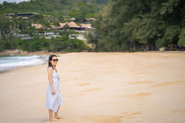 Young woman standing at sea shore.