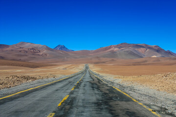 road leading into mountains in altiplano desert