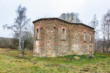 Fototapeta na wymiar Branisov / Czech Republic - November 15 2020: View of the ruined baroque church of St. Blazej with no roof made of stones and bricks, a former pilgrimage church. It is surrounded with birch trees.