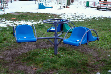 small carousel on the playground at the beginning of winter