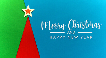 Flat lay of minimalist simple christmas tree a triangle shape made from coloured papers creativity geometry shape layouts greeting card copy space