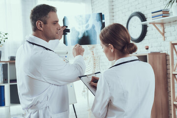 Male and female doctors with stethoscopes.