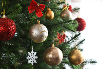 Christmas decoration. Christmas fir with balls of boxes with gifts in the room.