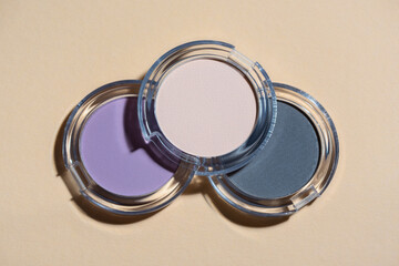 Creative concept photo of cosmetics beauty eyeshadow on beige background