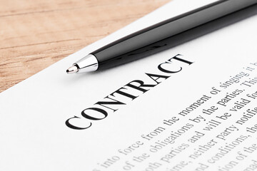 Pen lying on a contract or application form. Close up.