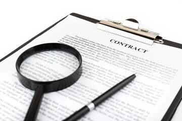 Magnifier and pen lying on a contract or application form on white table. Close up.