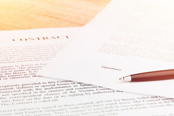 Pen lying on a contract or application form. Close up.