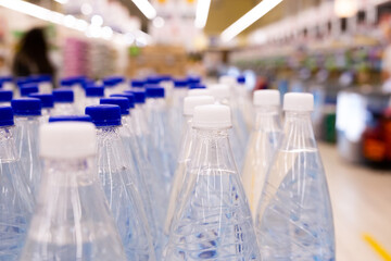 water bottles with blue caps in supermarket