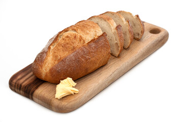 Fresh daily baking healthy plain sourdough loaf placing on top of cutting wooden board sliding into small pieces decorating with butter on the corner isolated white background 