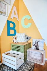 Stylish children's room with boxes and toys modern interior with letters. The concept of room for the baby.