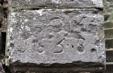 Close Up of Eroded Date on Old Carved Stone Tablet 