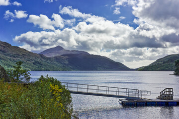 The pier at Inveruglas on Loch Lomond in the Trossachs area of Scotland, with the mountain peak of Ben Lomond rising high in the background.