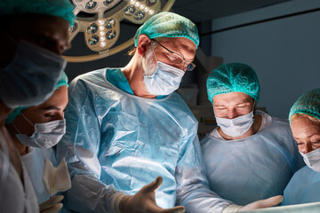 operating room caucasian team of professional surgeons and nurses working together, group of...