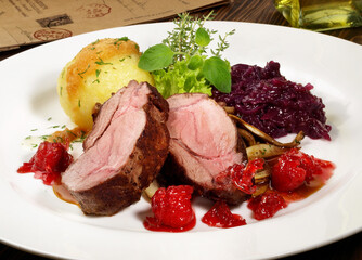 Wild Boar Steak with red Cabbage and Potato Dumpling - Isolated