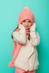 Little girl wearing warm winter hat and scarf