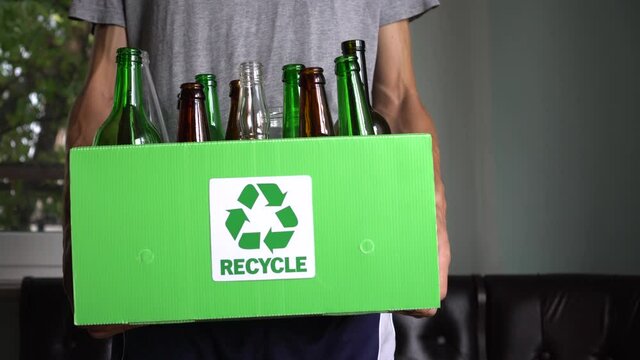Separate bin for glass recycling. Container for glass bottles and jars at home. Zero waste lifestyle. Recycle at Home: Glass, Compost, Paper, and Plastic