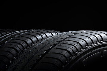 Tires ot tyres in a row on black background