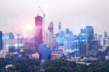 World planet Earth map hologram over panorama city view of Bangkok, Asia. The concept of international connections and business. Multi Exposure.