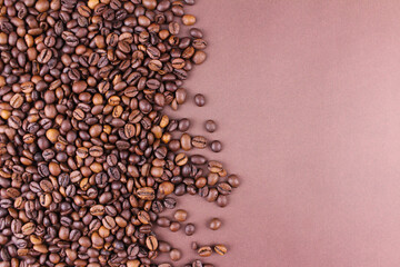 Brown background with roasted coffee beans