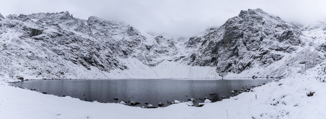Beautiful view of idyllic winter with crystal clear mountain lake at Eye of the Sea or Morskie Oko,...