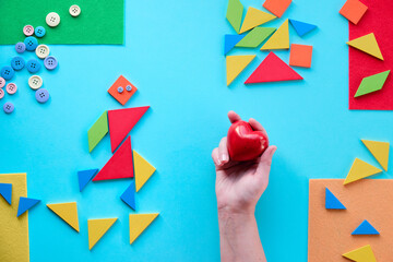 Geometric design for Autism World day with tangram puzzle triangles, pictogram and hand with heart