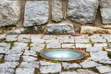 built-in cobblestone street lamp, part of the wall.