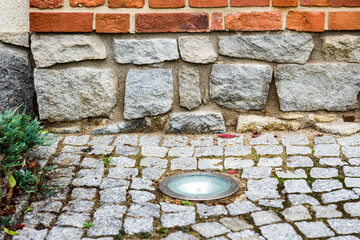 built-in cobblestone street lamp, part of the wall.