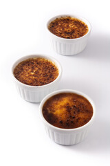 Homemade creme brulee in bowl isolated on white background