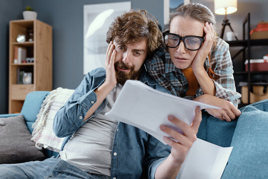 Sad young couple checking their bills