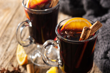 Traditional mulled wine with spices on rustic wooden table