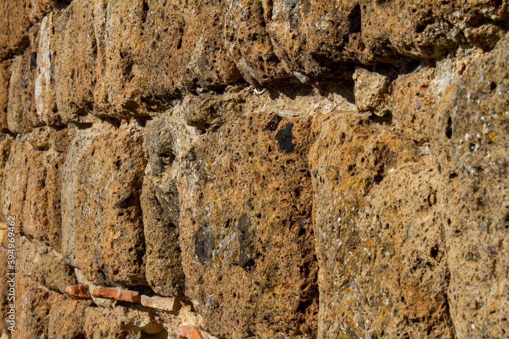 Wall mural the pattern layers of rocks inside civita di bagnoregio, ancient house building with brick red stone