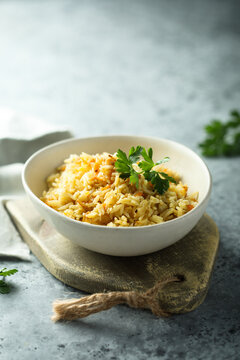 Homemade spicy rice with carrot and fresh parsley