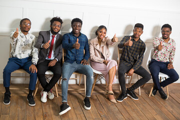 team of young african people indoors with hand gesture