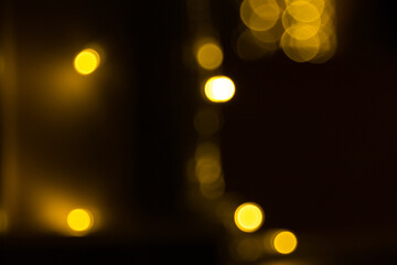 Defocused garland lights, Bokeh effect. Sparkling and fairy background. Christmas and New Year holidays concept.