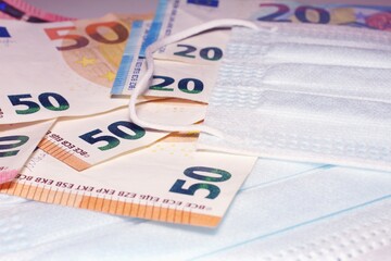surgical mask with a euro banknote, concept of Corona Virus in Europe