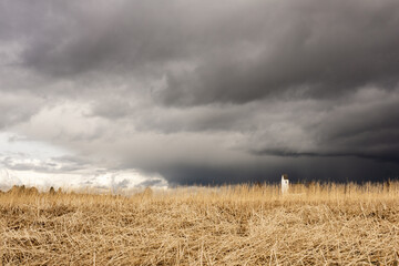 Church in a field during stormy weather conditions, mix of peace and calm and dramatic change....