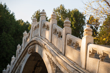 Fototapeta premium Chinese stone bridge and trees in autumn