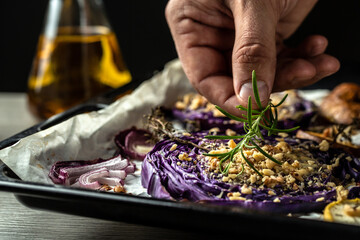 chef cooking traditional German dish of red cabbage baked with nuts, quince and apples, Vegan...