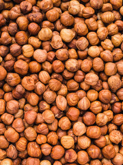 texture of many hazelnuts without shell - vertical background