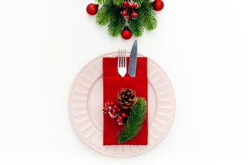 Table setting with spruce, plate, flatware on white background top view