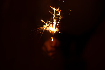 burning sparkler on a black background