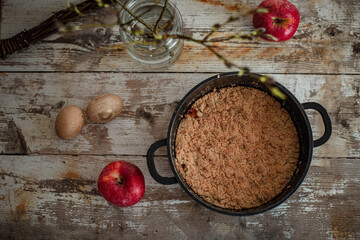 Flat lay photo of pot with old fashioned apple crumble baked during Easter.