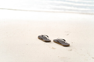 Fototapeta na wymiar flip flops on the beach background.