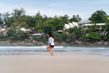 Cute little girl playing at shore.
