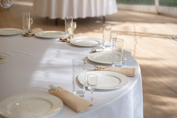 Table setting element empty plates with cutlery on white tablecloth