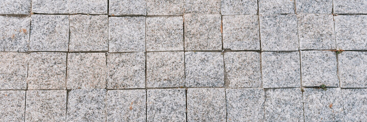 Texture of gray stone paving stones in close-up